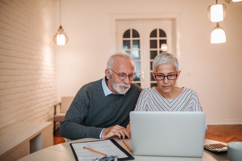 Senior couple reviewing their mortgage information on a laptop