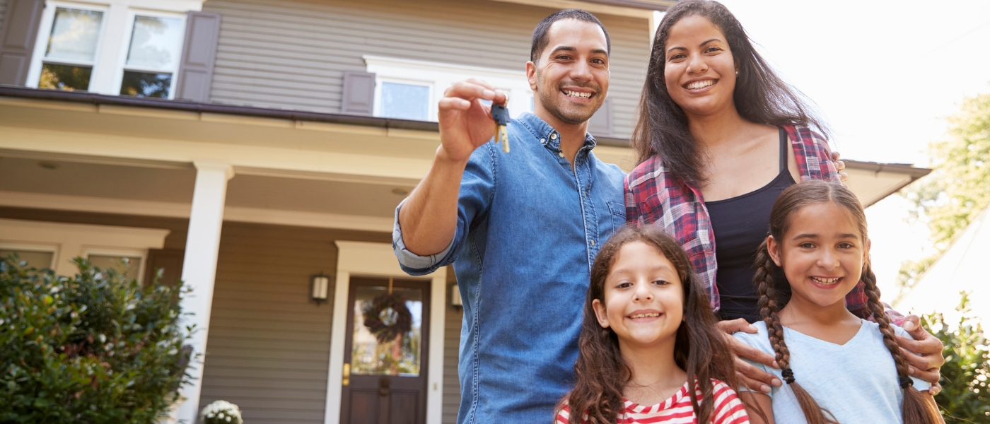 Family standing in front of new home